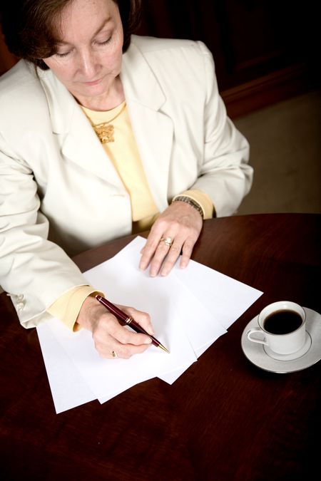 Female Entrepreneur Doing Paperwork While Working In An Office Stock Photo Image Of Person